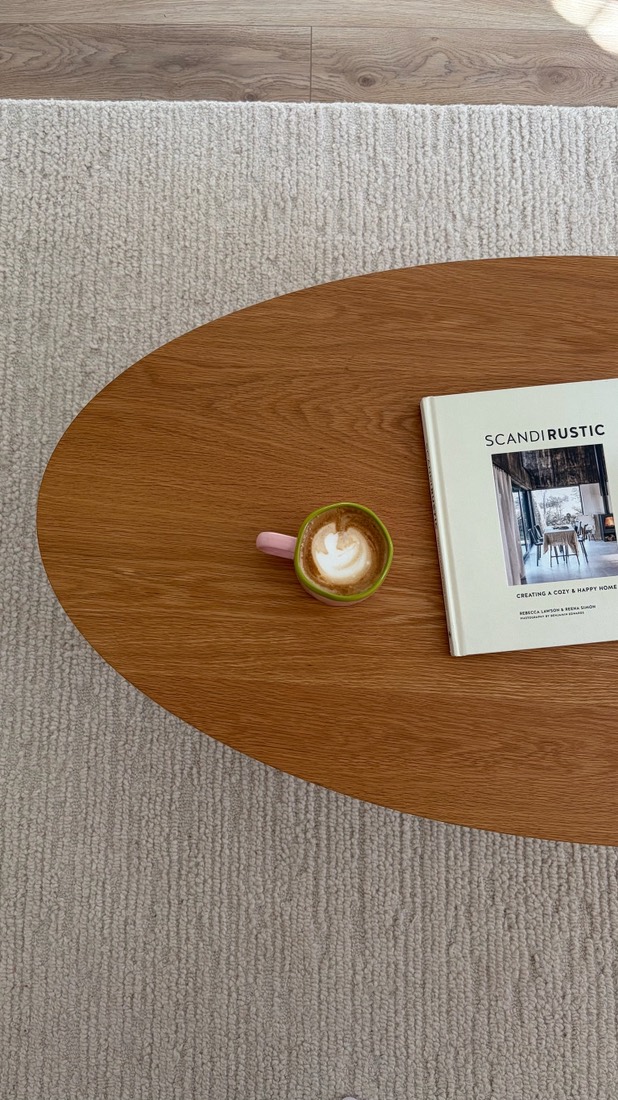 Latte and a book on an oak coffee table